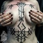 фото женское тату руны на груди